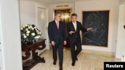 Colombia's President Juan Manuel Santos, right, and President-elect Ivan Duque walk through the presidential palace, in Bogota, Colombia June 21, 2018. 