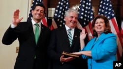 FILE - Speaker of the House Paul Ryan, R-Wis. (L), Representative-elect Karen Handel, R-Ga.(R), and her husband Steve Handel participate in a ceremonial swearing-in on Capitol Hill in Washington, June 26, 2017. 