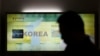 FILE - A man passes by a map of the Korean peninsula at the Unification Observation Post near the demilitarized zone between the two Koreas in Paju, north of Seoul, South Korea, March 28, 2013.