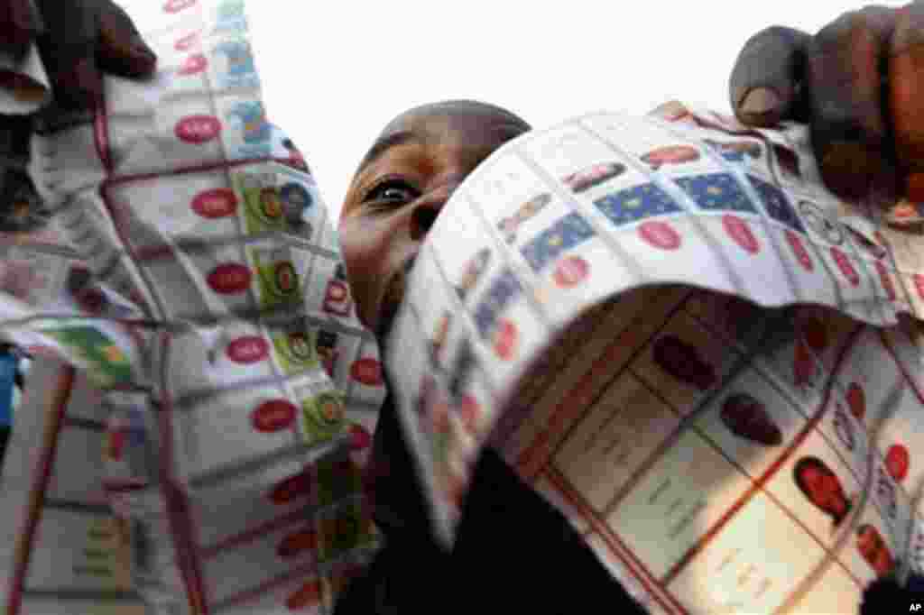 Supporters of oppositions candidate Etienne Tshisekedi parade what they claim are badly printed fraudulent photocopies of election ballots they say they found in the Bandal commune in Kinshasa, Democratic Republic of Congo, Monday Nov. 28, 2011. Polls 