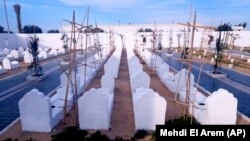 The cemetery for migrants who have died trying to reach Europe, in the village of Zarzis, Tunisia, Saturday June 12, 2021. A newly sanctified cemetery for Tunisia's migrant dead is filling quickly. Rachid Koraïchi bought the plot of land in the port city of Zarzis a few years ag