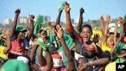Supporters of presidential candidate John Magufuli of the ruling Chama Cha Mapinduzi party cheer at an election rally in Dar es Salaam, Tanzania, Oct. 23, 2015.