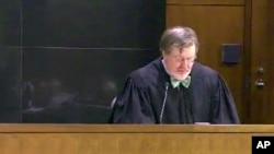 FILE - This image taken from United States Courts shows Judge James Robart listening to a case, March 12, 2013, in Seattle, Washington. Robart placed a nationwide hold on President Donald Trump's executive order banning travel to the United States by migrants from seven Muslim-majority countries.
