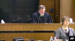 FILE - This image taken from United States Courts shows Judge James Robart listening to a case at the Seattle Courthouse, March 12, 2013, in Seattle, Washington.