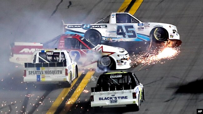 Ty Majeski (45), Austin Wayne Self (22), Brennan Poole, delantero izquierdo y Todd Gilliland, delantero derecho, chocaron temprano en la carrera de autos NASCAR Truck Series en el Daytona International Speedway, el viernes 14 de febrero de 2020 en Daytona Playa, Florida