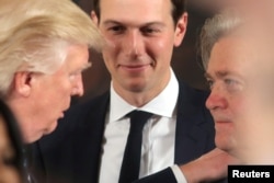 President Donald Trump talks to Steve Bannon, right, and Jared Kushner during a swearing in ceremony for senior staff at the White House, Jan. 22, 2017.