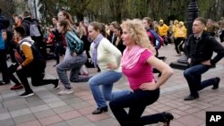 People make outdoor sport exercise to mark World Health Day in Kiev, Ukraine, Friday, April 7, 2017. The World Health Day is a global health awareness day celebrated every year on April 7, under the sponsorship of the World Health Organization (WHO). 