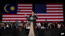 President Barack Obama gestures as he speaks during a town hall meeting at Malaya University in Kuala Lumpur, Malaysia, Sunday, April 27, 2014. 