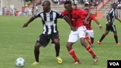 Highlanders striker Kasimero Chimbadzwa shields the ball from Chicken Inn defender Divine Lunga.