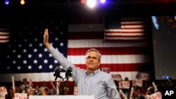 Former Florida Gov. Jeb Bush waves as he takes the stage as he formally announced he is joining the race for president with a speech, June 15, 2015, at Miami Dade College in Miami.