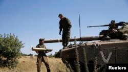 Tentara Israel dengan tank mereka di dekat Alonei Habashan, di daerah Dataran Tinggi Golan yang dikuasai Israel (22/6). 