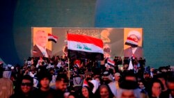 FILE - Followers of a political movement called "Al-Fateh Alliance" chant during a rally before the parliamentary elections in Baghdad, Iraq, Oct. 7, 2021.