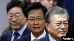 The Democratic Party's candidates for the presidential primary Moon Jae-in, Choi Sung and Lee Jae-myung (R-L) attend an event to declare their fair contest in the party's presidential primary in Seoul, March 14, 2017.