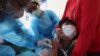 FILE -A young boy reacts as he receives a shot of the Sinovac's COVID-19 vaccine at a Samrong Krom health center outside Phnom Penh, Cambodia, Friday, Sept. 17, 2021. (AP Photo/Heng Sinith)