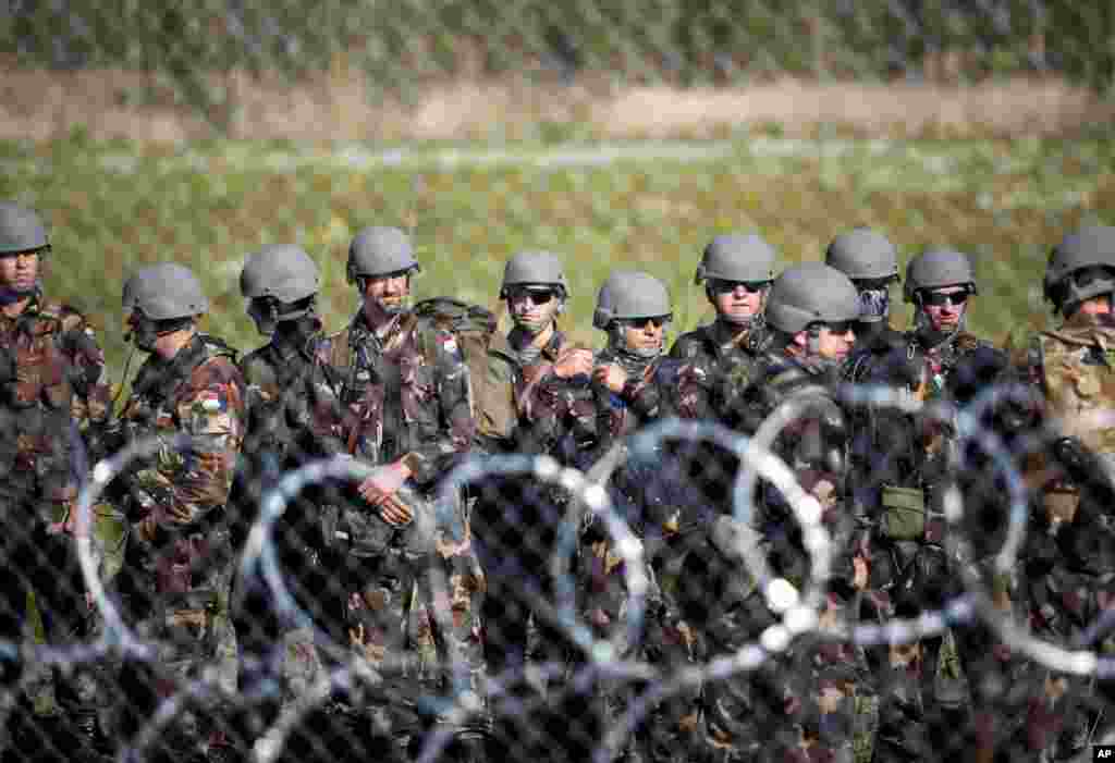 Soldiers are seen at the border between Hungary and Serbia, near Roszke, 180 kms southeast from Budapest, Hungary, Sept. 14, 2015. European Union interior ministers meet for emergency migration talks, a day after Germany reintroduced checks at its border with Austria to stem the continuing flow of refugees.