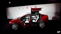 FILE - The Tesla Model X car is introduced at the company's headquarters in Fremont, California, Sept. 29, 2015. 