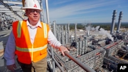 Mississippi Power spokesman Lee Youngblood talks about a carbon capture power plant from the top floor of its gasifier unit, some 66 meters above the pine forests and pastures of DeKalb, Miss., Nov. 16, 2015.
