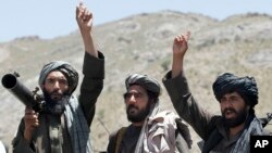 FILE - Taliban fighters react to a speech by their senior leader in the Shindand district of Herat province, Afghanistan, May 27, 2016. An Afghan civil society organization is working on its own to organize a meeting in the Gulf later this month between the Taliban and influential members of the Afghan Society.