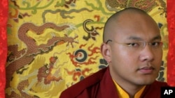 Karmapa Lama, the third highest ranking Lama, pauses during an interview with Reuters in the northern Indian hill town of Dharamsala March 2, 2009. He is a "living Buddha" with an iPod, the 23-year-old possible successor to the Dalai Lama who may bridge t