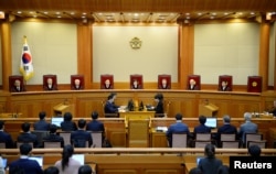 South Korean acting Constitutional Court's Chief Judge Lee Jung-mi (center) and seven judges during final ruling of President Park Geun-hye's impeachment at the Constitutional Court in Seoul, South Korea, March 10, 2017.