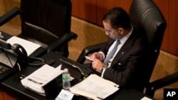 FILE - Senator Javier Lozano of the National Action Party uses his cellphone during a legislative session in Mexico City, July 4, 2014. Experts confirmed June 29, 2017, that leading members of the National Action Party were targeted by Israeli-made spyware sold exclusively to governments.