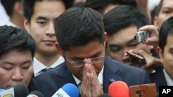 Leader of Thai Raksa Chart party Preechapol Pongpanich, center, gestures as he talks to media at the Constitutional Court in Bangkok, Thailand, Thursday, March 7, 2019. 