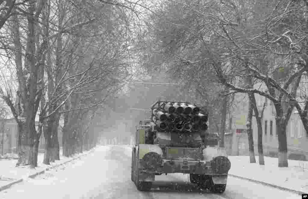 The Ukrainian government and Russia-backed rebels accused each other of violating a cease-fire in eastern Ukraine one day before the parties are due to start withdrawing heavy weaponry under a recently brokered deal. In this photo, a Ukrainian truck with a &quot;Smerch&quot; missile launcher drives through the streets of Artemivsk, Ukraine, Feb. 16, 2015.