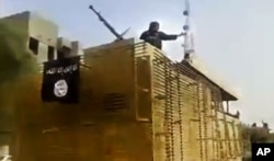 FILE - This June 2014 image taken from video shows Islamic State militants arriving at an oil refinery in Beiji, Iraq.