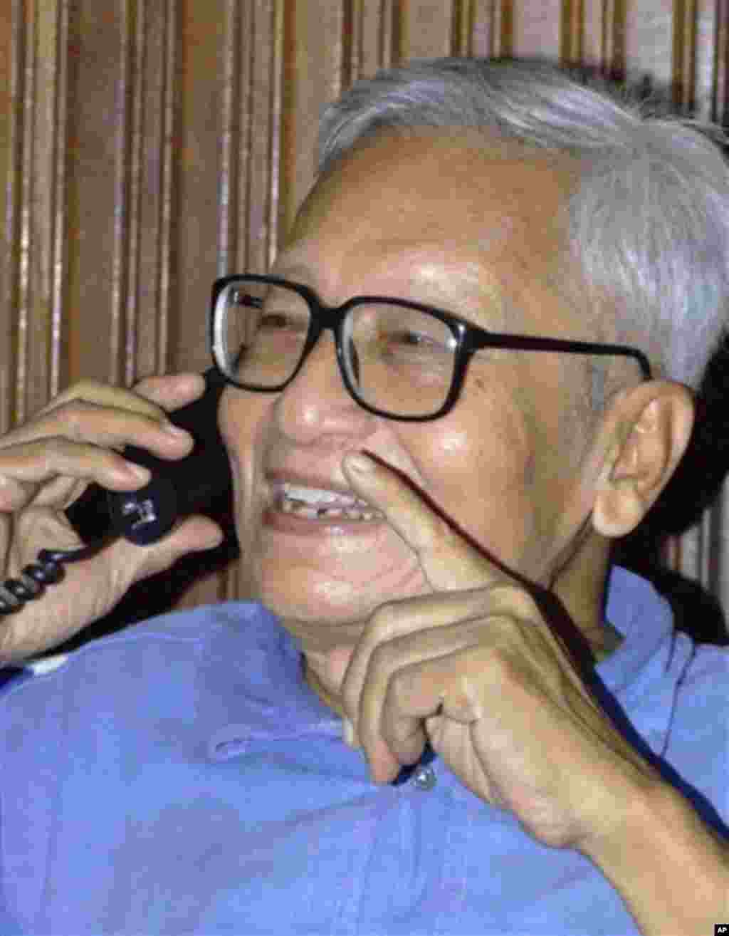 Myanmar's political prisoner Win Tin, 78, smiles as he speaks on a telephone at his friend's house following his release in Yangon, MyanmarTuesday Sept. 23, 2008. Myanmar's longest-serving political prisoner, journalist Win Tin, was freed Tuesday after 19
