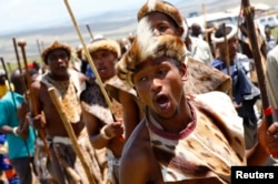 Zulu warriors dance to honor South Africa's late President Nelson Mandela on a hill above the graveyard within the Mandela family's property in the village of Qunu where Mandela was buried, Dec. 15, 2013.