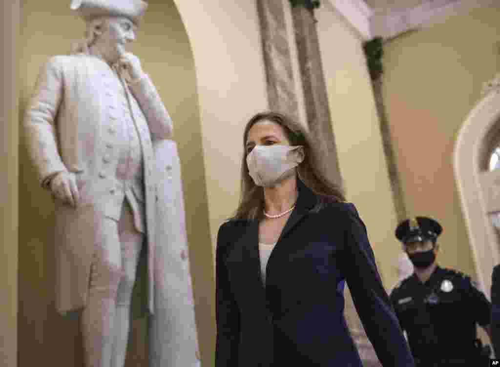 Judge Amy Coney Barrett, President Donald Trump&#39;s nominee for the Supreme Court, arrives for closed meetings with senators, at the Capitol in Washington, Wednesday, Oct. 21, 2020. (AP Photo/J. Scott Applewhite)