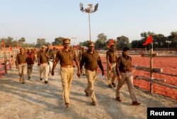 Police officers patrol the venue of Sunday's "Dharma Sabha" or a religious congregation organized by the Vishva Hindu Parishad (VHP), a Hindu nationalist organization, in Ayodhya, Uttar Pradesh, India, Nov. 24, 2018.