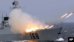 资料照：中国海军舰只在演习中发射反潜导弹