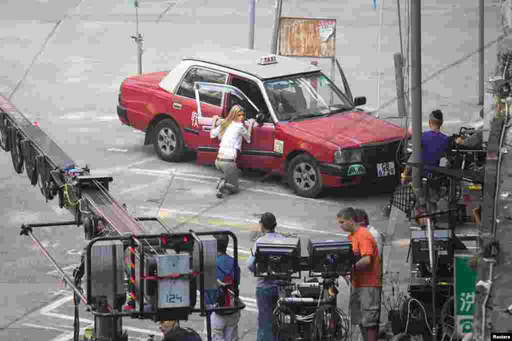 Cast member Nicola Peltz acts during the filming of a scene for the movie "Transformers: Age of Extinction" in Hong Kong. The shooting continued after the police arrested a suspected triad member following an attempt to extort money from the crew. It was the second attempt in five days to blackmail the Paramount Pictures crew, local media reported.