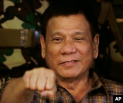 Philippine President Rodrigo Duterte, sen in this Aug. 25, 2016, gestures with a fist bump during his visit to the Philippine Army's Camp Mateo Capinpin at Tanay township, Rizal province east of Manila, Philippines. The Philippine president has apologized Philippine President Rodrigo Duterte gestures during his visit to the Philippine Army's Camp Mateo Capinpin at Tanay township, Rizal province east of Manila, Philippines.