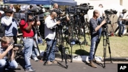 FILE - Journalists report from Johannesburg, South Africa, Sept. 2, 2013. Newsroom raids, attacks on journalists and press freedom violations highlight the challenges facing independent media across Africa in 2023, analysts say.
