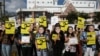 FILE - Demonstrators hold signs and masks as they protest on the six-month anniversary of pro-democracy activist Wanchalearm Satsaksit's abduction, in front of the Cambodian embassy in Bangkok, Thailand, December 3, 2020. (REUTERS/Soe Zeya Tun)