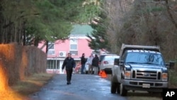 FILE - An entrance to the grounds of a riverfront compound near Centreville, Maryland, that has been used by Russian Federation diplomats for years is blocked to reporters by state department personnel, Dec. 29, 2016. 