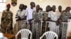 FILE - South Sudanese soldiers listen to the guilty verdict being delivered Sept. 6, 2018, at their trial for rape and murder in a violent rampage in 2016 at a Juba hotel.