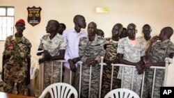 FILE - South Sudanese soldiers listen to the guilty verdict being delivered, Sept. 6, 2018, at their trial for rape and murder in a violent rampage in 2016 at a Juba hotel.