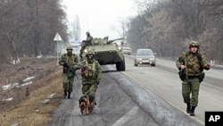 FILE - Interior Ministry officers patrol a road in the Russian North Caucasus on the hunt for Islamic State rebels, Jan. 28, 2011.