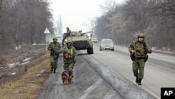 Interior Ministry officers patrol a motorway from the town of Malgobek to Nazran in the Russian southern region of Ingushetia, January 28, 2011.