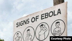 FILE: A sign displays the symptoms of Ebola.