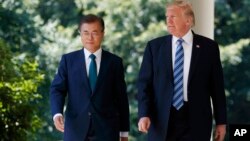 FILE - U.S. President Donald Trump walks with South Korean President Moon Jae-in to make statements in the Rose Garden at the White House in Washington, June 30, 2017. 
