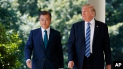 FILE - U.S. President Donald Trump walks with South Korean President Moon Jae-in to make statements in the Rose Garden at the White House in Washington, June 30, 2017. 