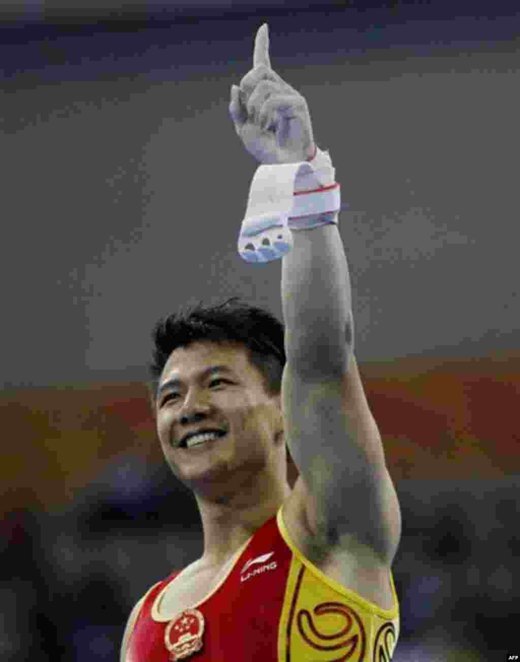 China's gymnast Chen Yibing, gestures after completing his routine on the men's rings at the 16th Asian Games in Guangzhou, China, Tuesday, Nov. 16, 2010. Chen won the gold medal. (AP Photo/Ng Han Guan)