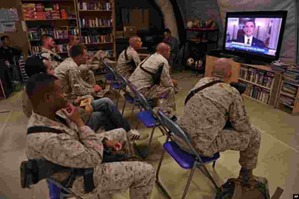 US Marines of Regiment Combat Team 1 watch TV as President Barack Obama announces the death of Osama Bin Laden, at Camp Dwyer in Helman Province, on May 2, 2011.