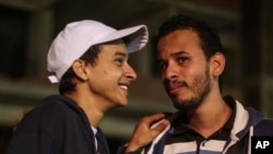 Egyptian activist Mahmoud Mohammed Ahmed, left, smiles next to his brother, Tarek, after his release from a police station in Cairo, Egypt, March 24, 2016.