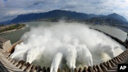 FILE - In this photo released by China's Xinhua News Agency, flow of water is discharged through the Three Gorges Dam in Yichang City, central China's Hubei Province.