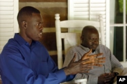 FILE - Abraham Akoi, left, and Emanuel Solomon discuss their experiences as young children in 1987 fleeing civil war in their home country of Sudan, in Sewanee, Tenn., May 24, 2005. Legislation introduced in the U.S. House seeks to help now-grown "lost boys" return to their homeland and help rebuild it.